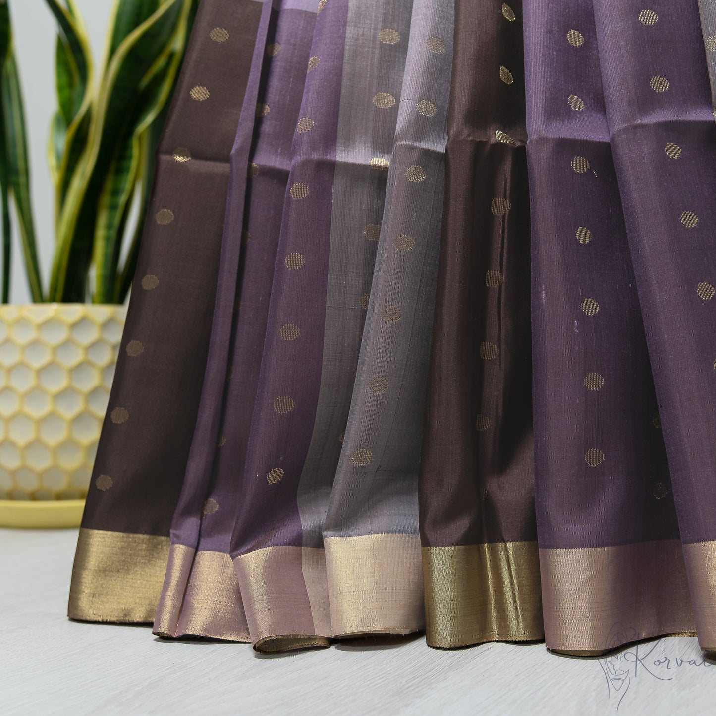 Pleated view of Purple and lilac boxed Kanjivaram soft silk saree with gold zari polka dots.