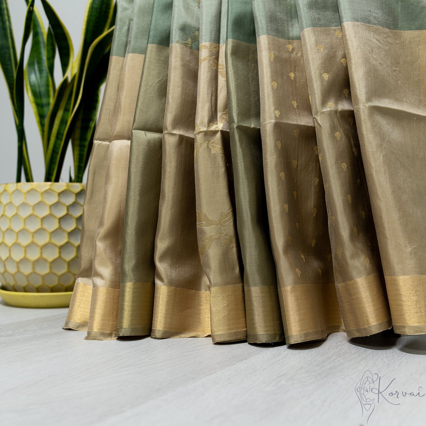 Pleated view of green boxed Kanjivaram soft silk saree.