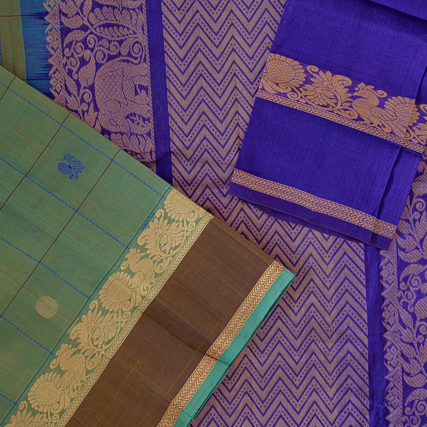 Green and cream shot coloured soft silk saree with closer view of dark blue pallu with intricate elephant motifs in gold.