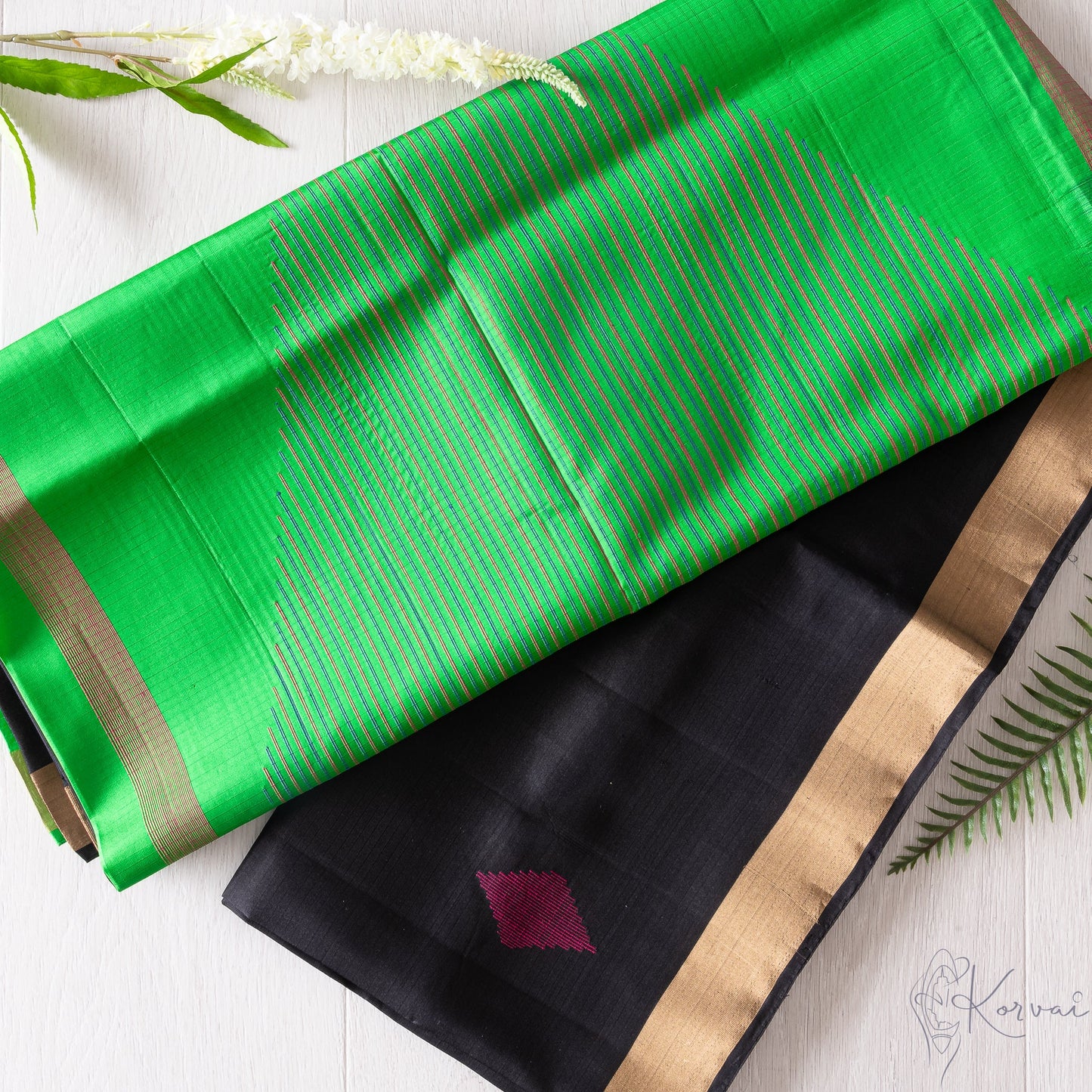 Black Kanjivaram soft silk saree with parrot green pallu.