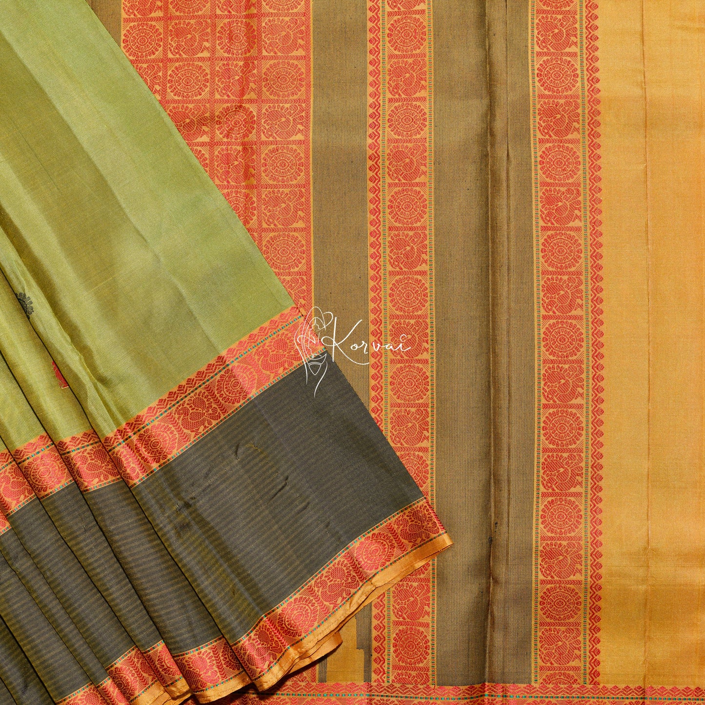 Green soft silk saree with peacock and wheel motifs in the body and same motifs in the pallu.