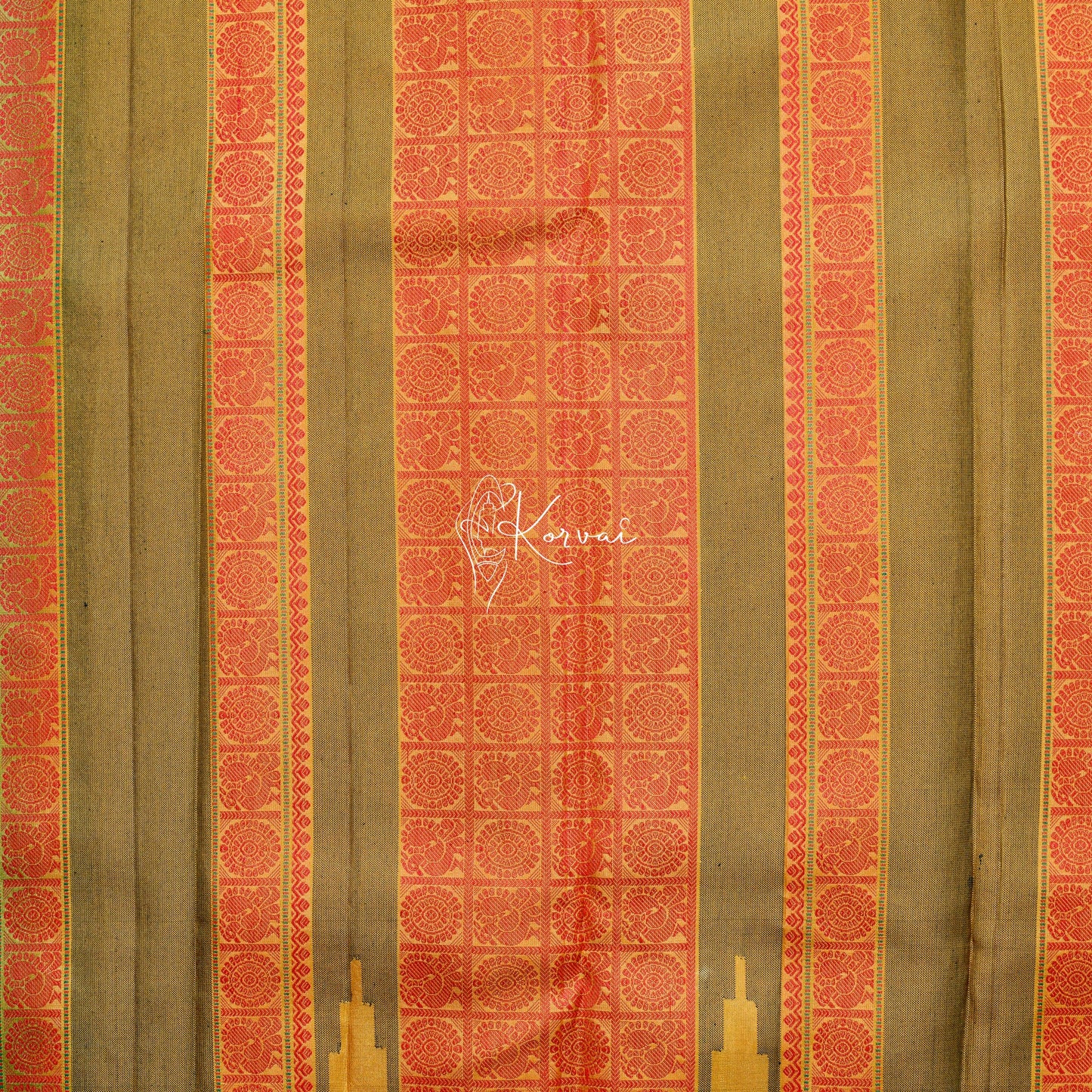 Closer view of the pallu with Peacock and wheel motifs in orange thread.