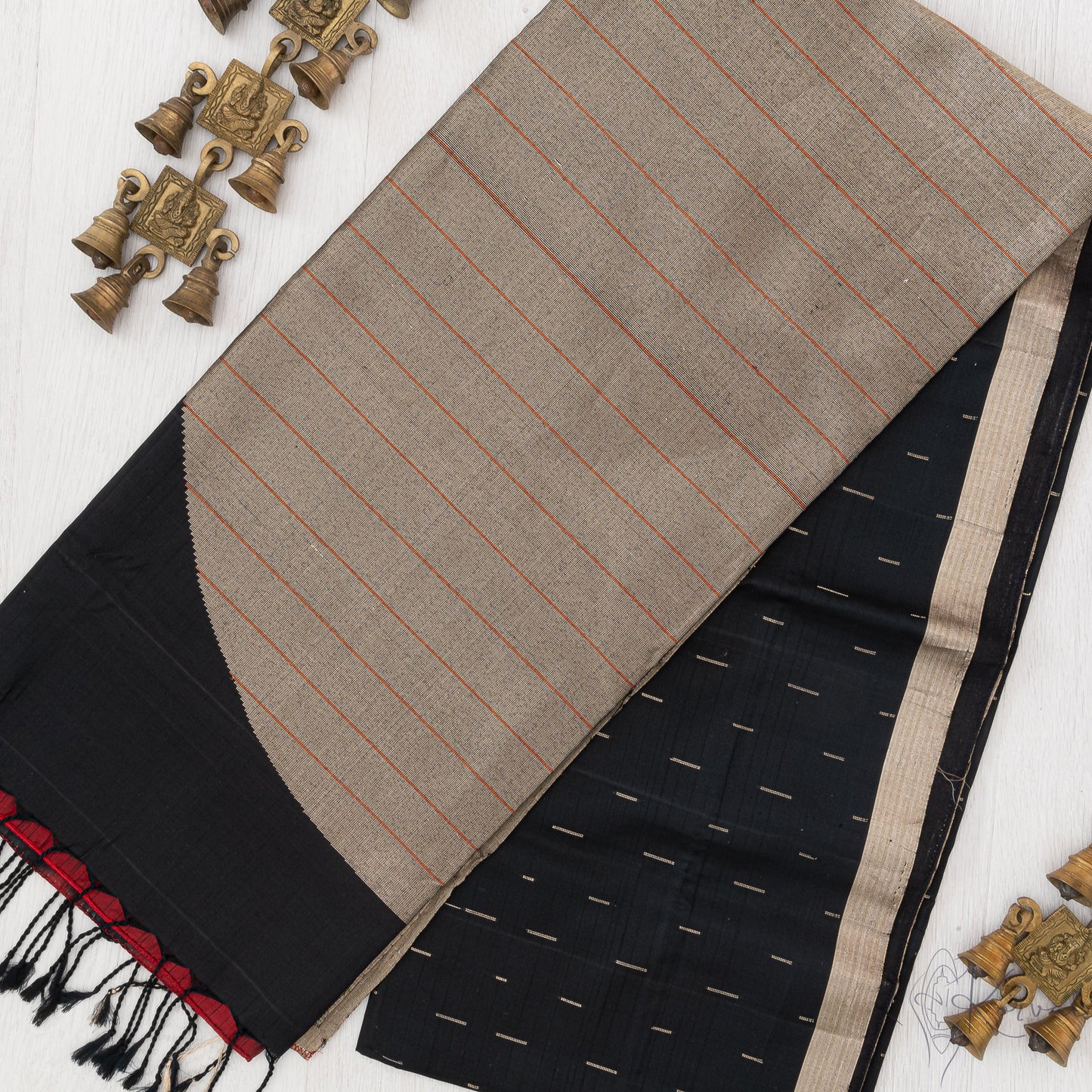 Jet black soft silk saree with gold border and raindrop motifs in the body.