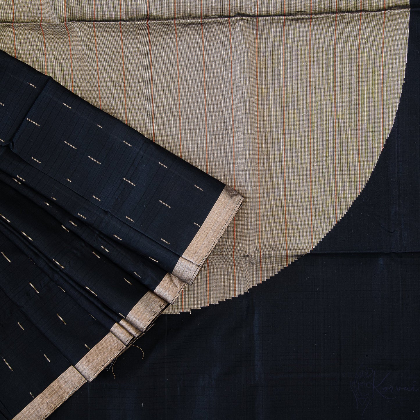 Jet black soft silk saree with a closer view of the pallu with a large circle motif in gold.