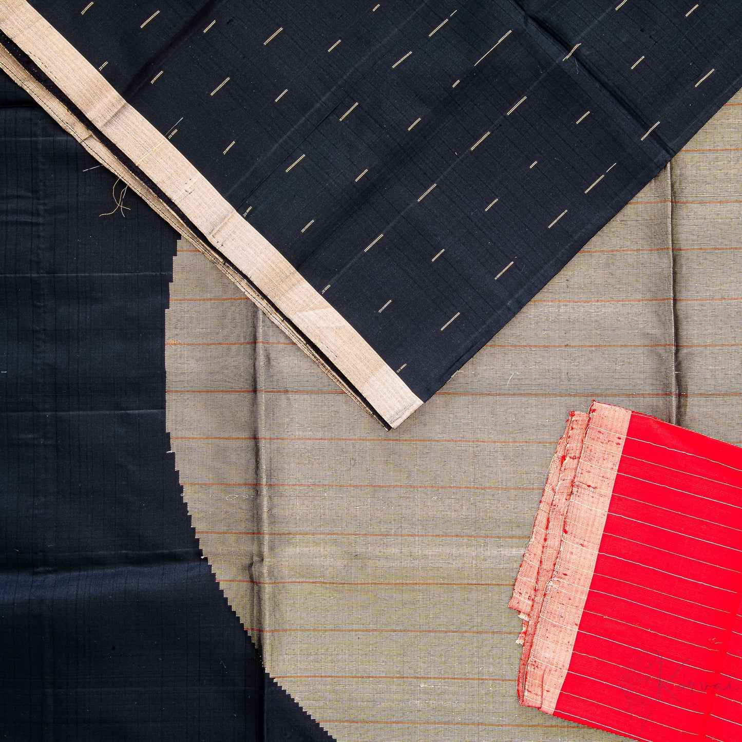 Jet black soft silk saree with a closer view of the pallu with a large circle motif in gold and red blouse fabric.