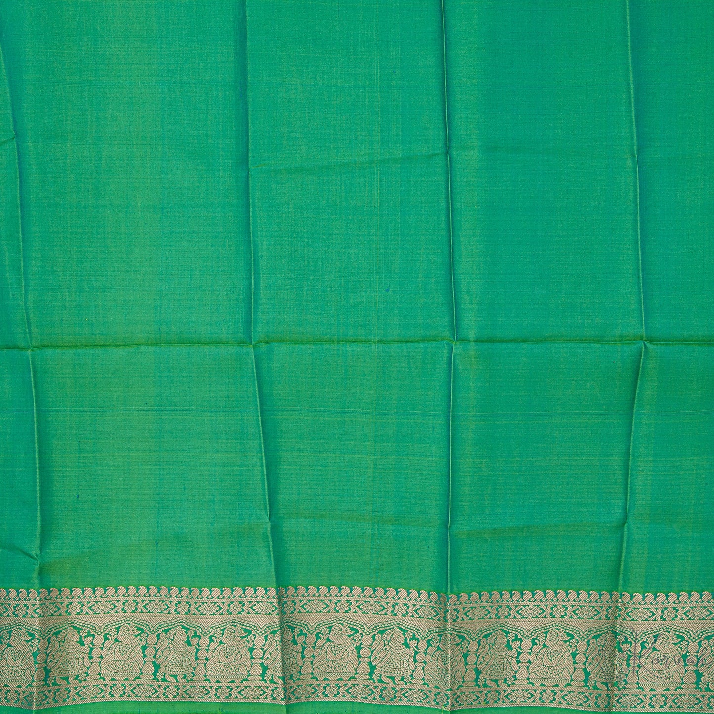 Closer view of the green blouse with gold zari work in border.