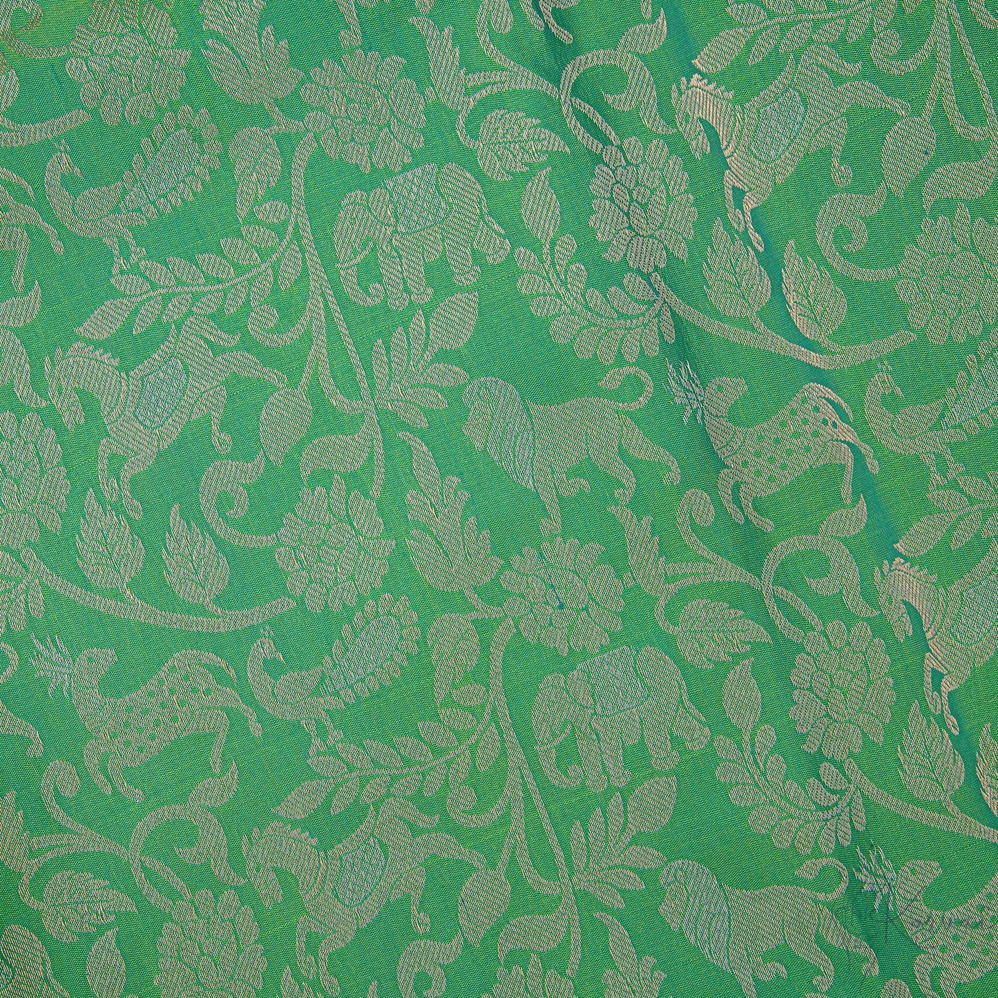 Closer view of the green body with forest animals and birds motifs.