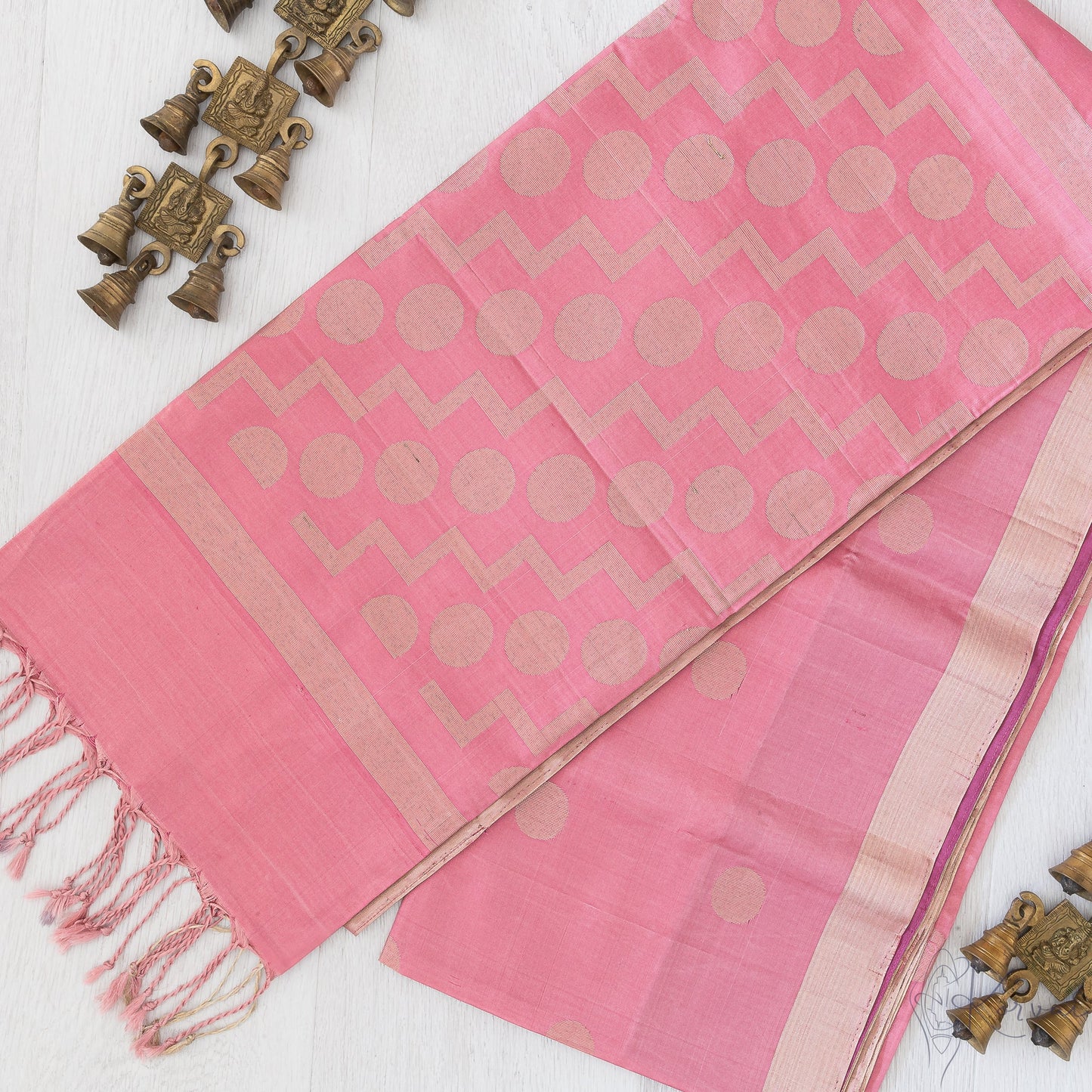 Pastel pink soft silk saree with retro style polka dot motifs.