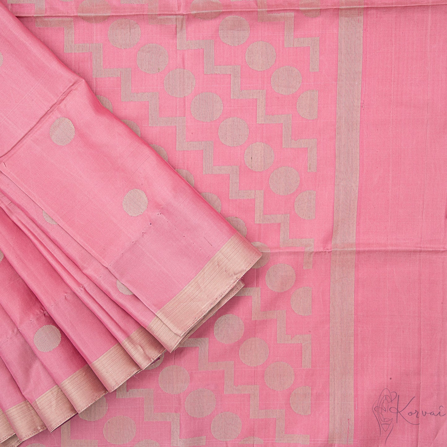 Top view of pastel pink soft silk saree with closer view of pallu that has polka dot motifs.