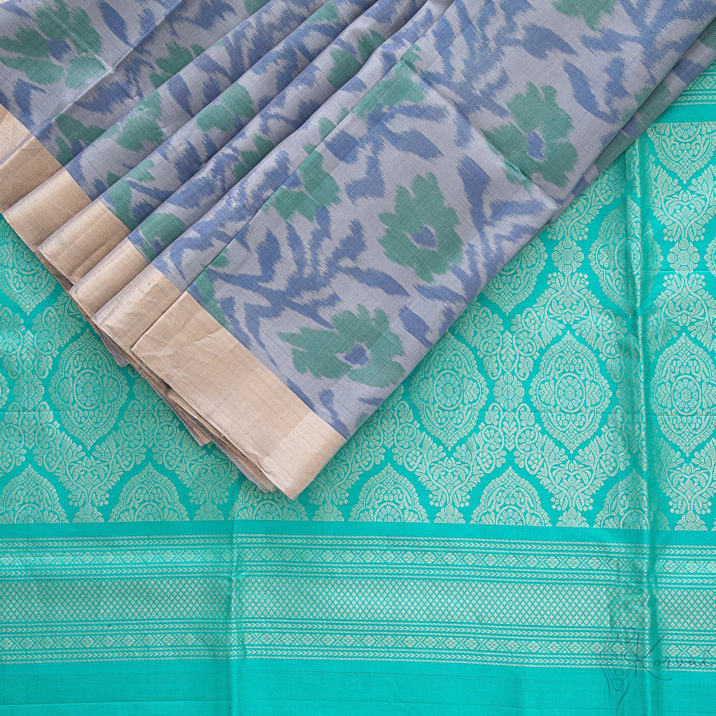 Top view of grey pochampally saree with a closer view of teal pallu with intricate gold design.