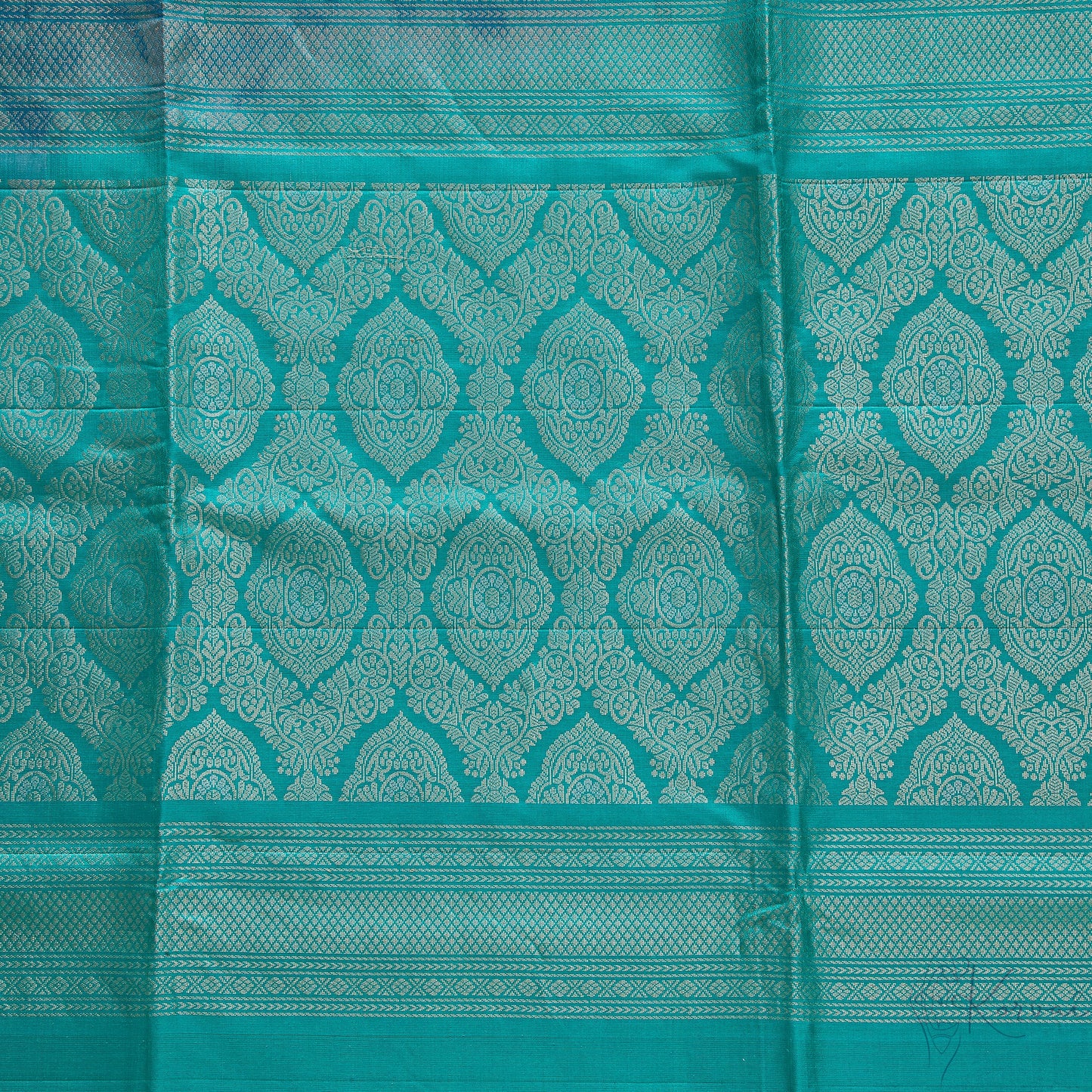 Closer view of teal pallu with intricate gold design.
