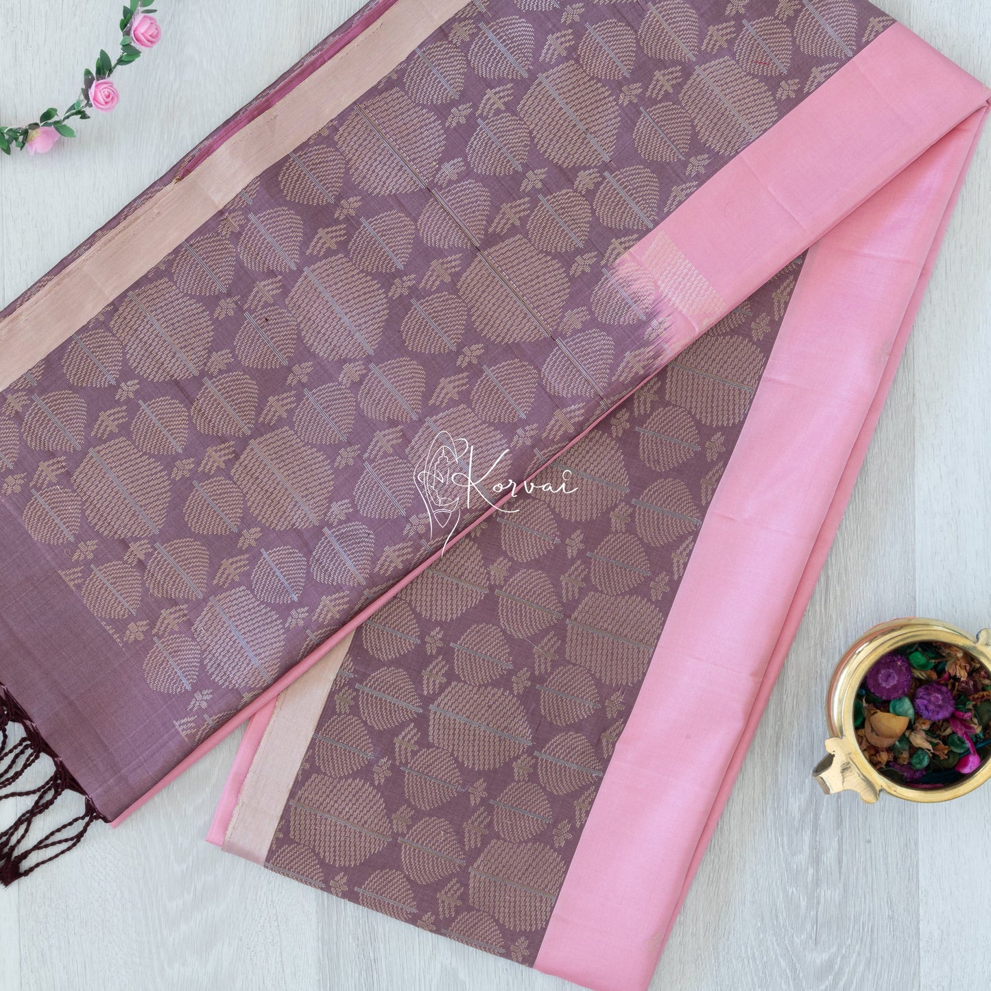 Top view of carnation pink coloured Kanjivaram soft silk saree with contemporary pallu in purple.