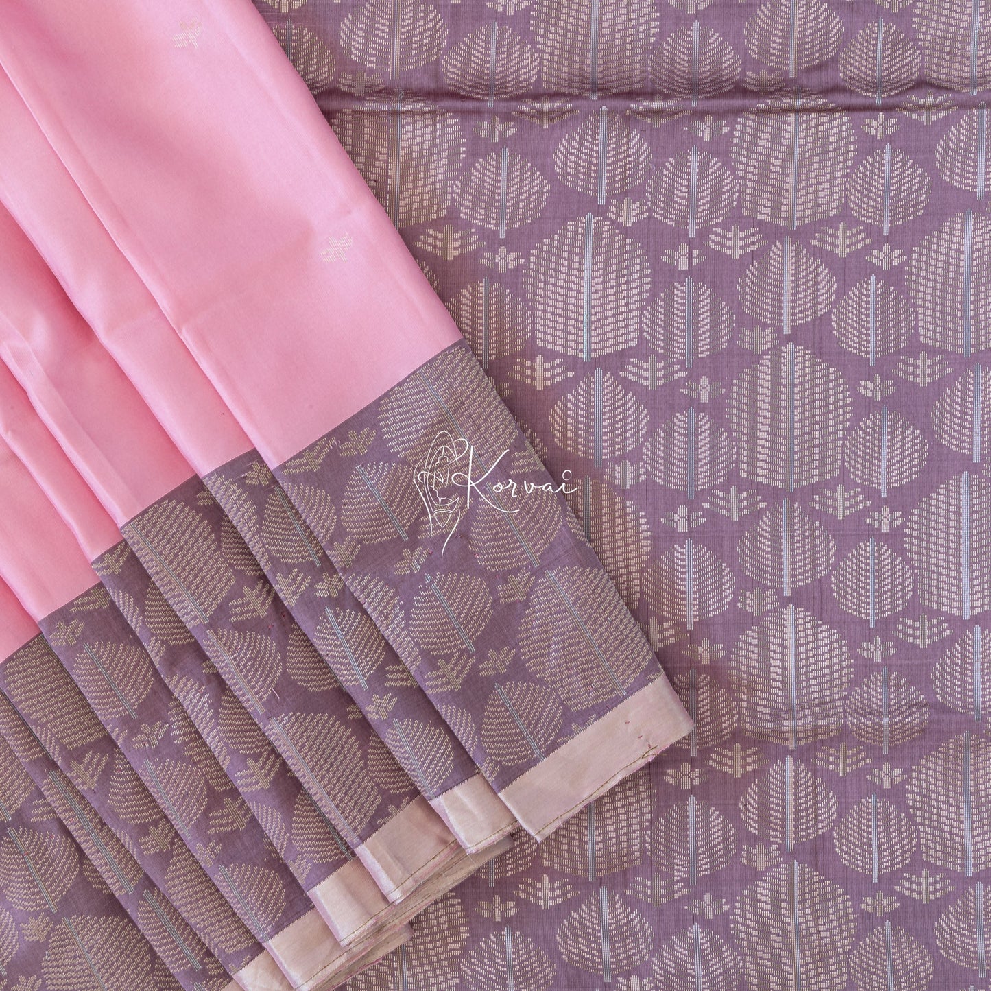 Carnation pink coloured soft silk saree with tiny flower motifs in the body.
