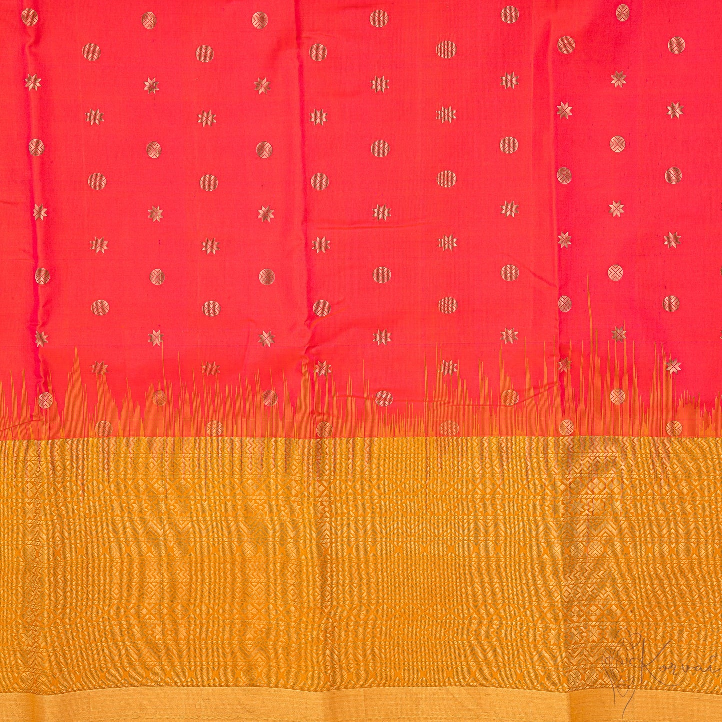 Closer view of pinkish red body with circle and star motifs and mustard pallu.