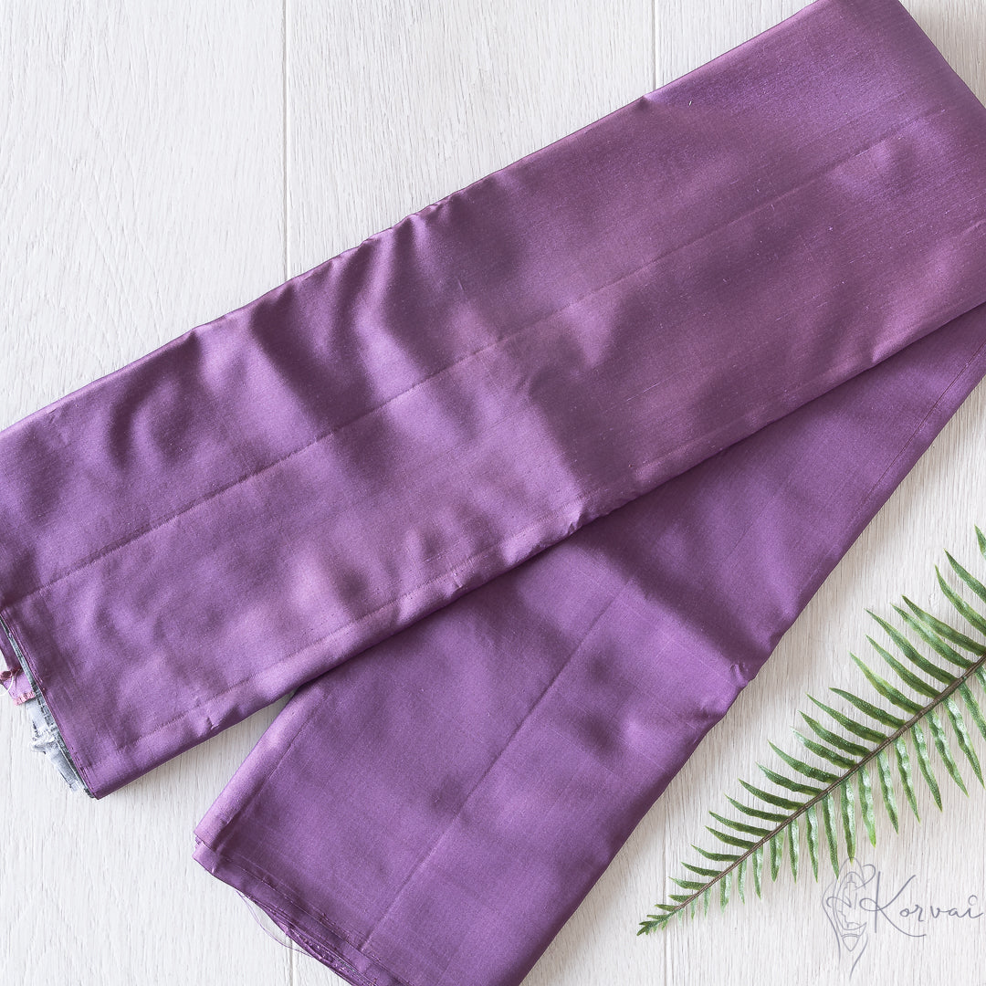 Purple plain Kanjivaram soft silk saree folded in half.