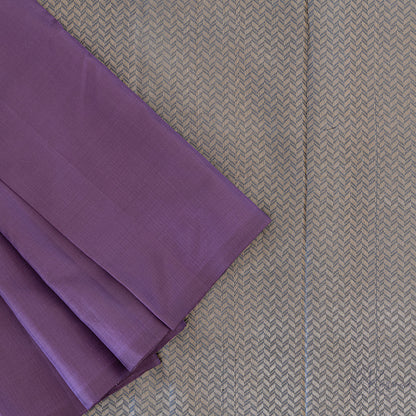 Top view of purple plain Kanjivaram saree with grey pallu that has intricate gold zari designs.