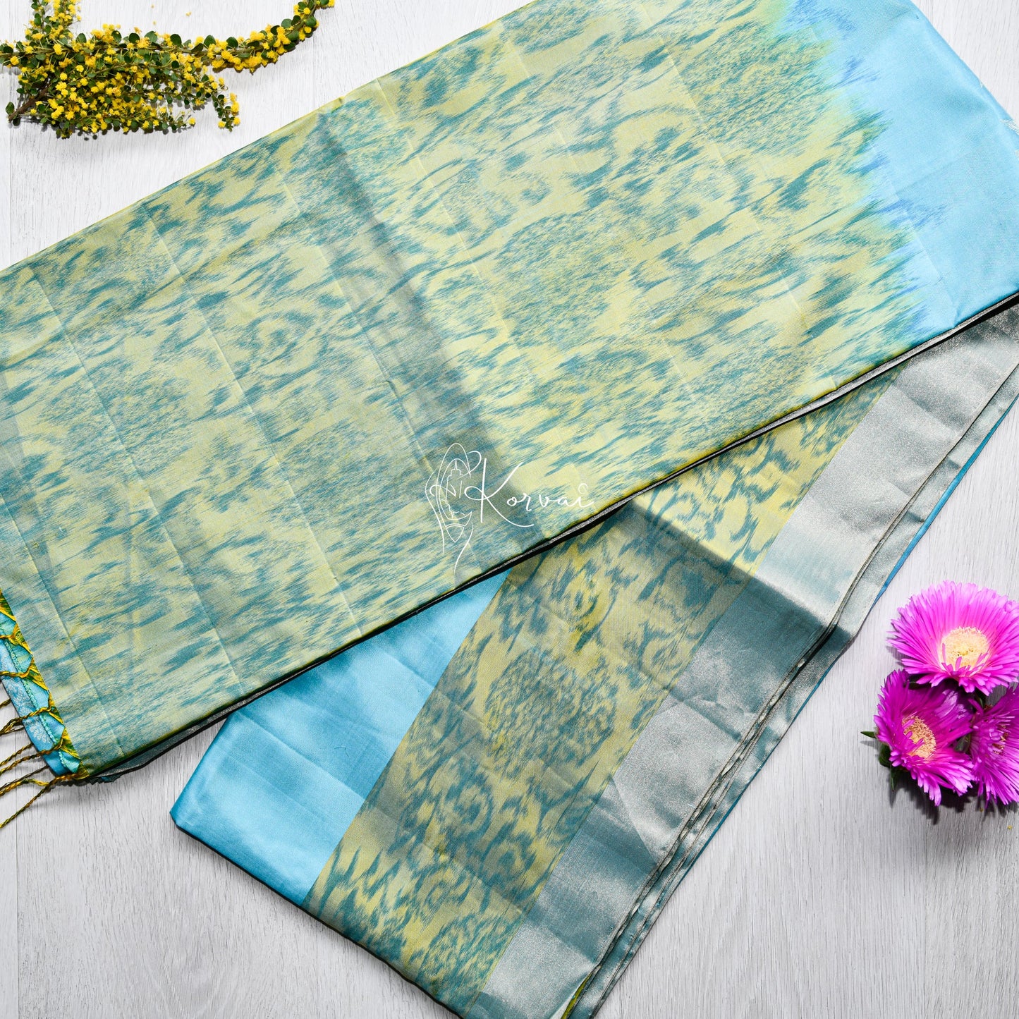 Top view of sky blue coloured soft silk saree pochampally print on the border and pallu.