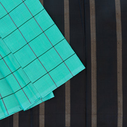 Top view of teal Kanjivaram saree with black large checks in the body and black pallu with gold zari designs.