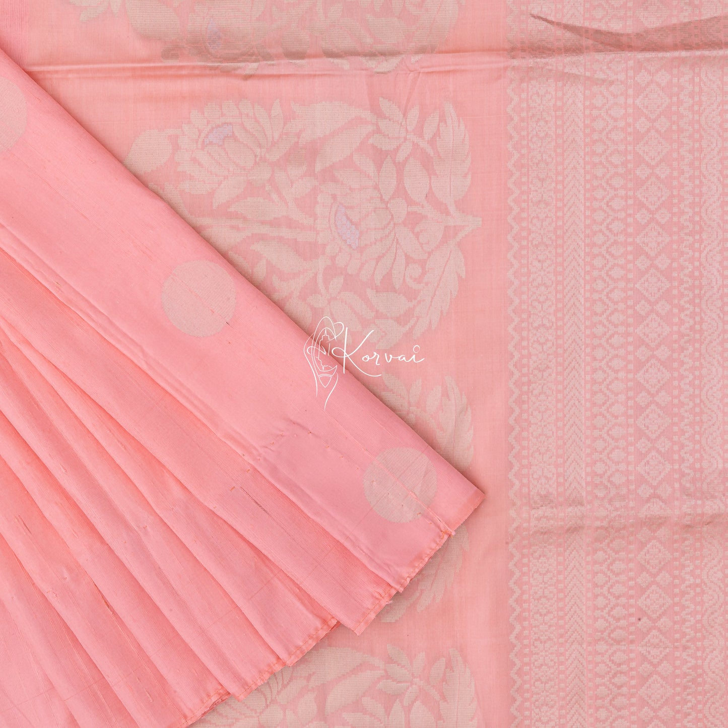 Pinkish peach raw silk saree with polka dot motifs in the body and sunflower motifs on the pallu.