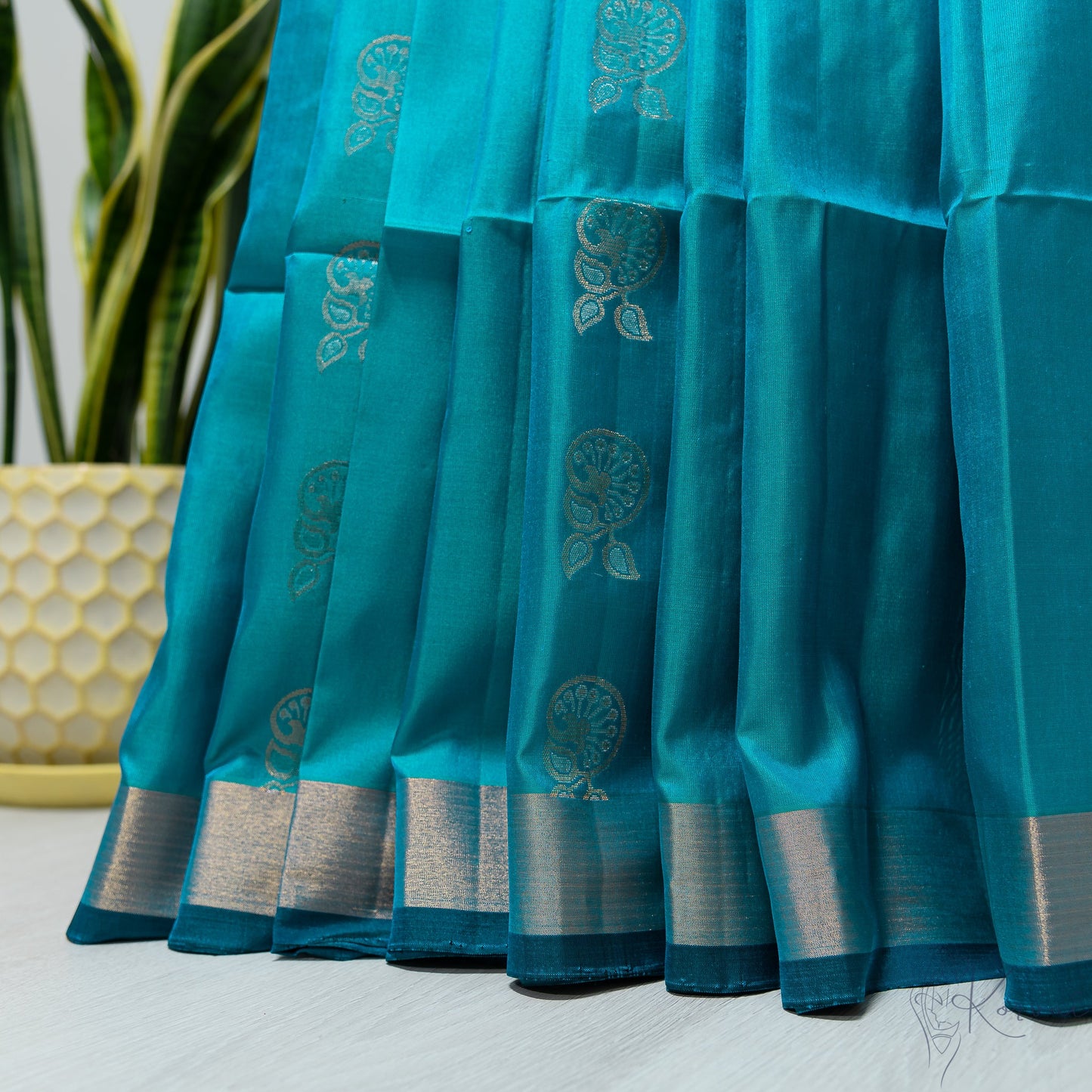 Sea blue Kanjivaram soft silk saree that is pleated.