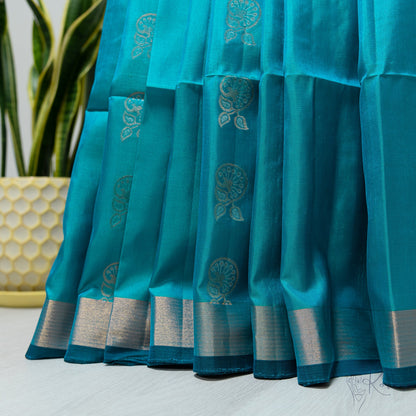 Sea blue Kanjivaram soft silk saree that is pleated.