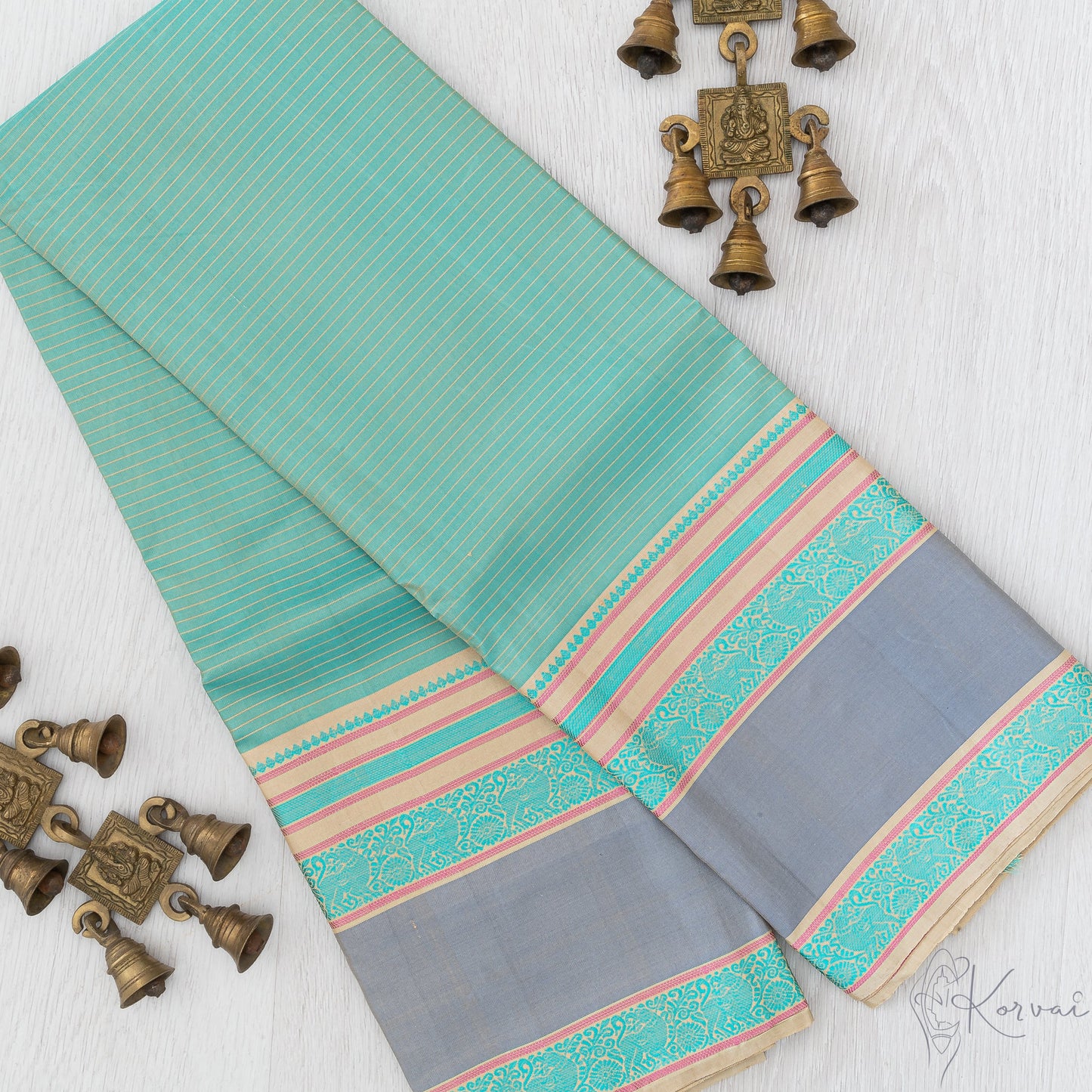 Pastel green Kanjivaram soft silk saree with cream coloured horizontal stripes along the body and has a double border in grey.