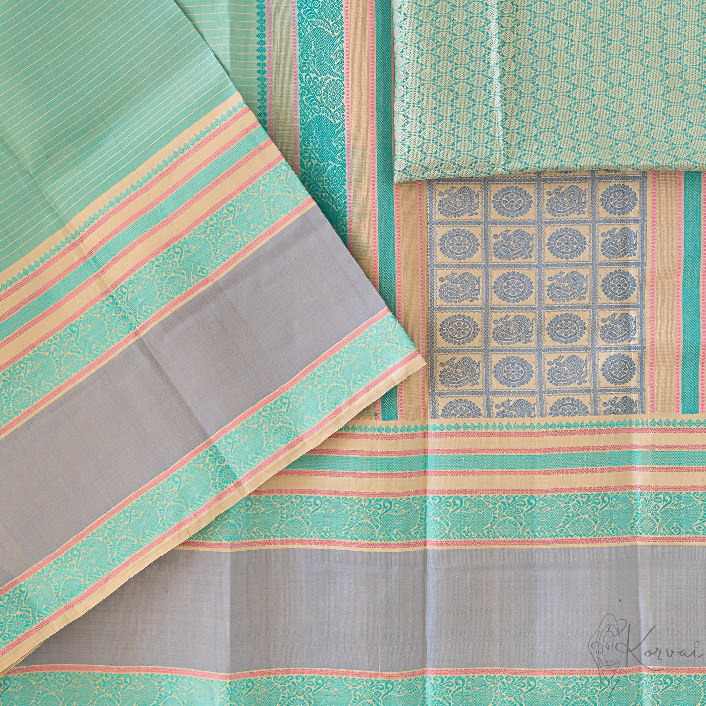 Pastel green Kanjivaram soft silk saree showing the pallu that has grey peacock and wheel threadwork.