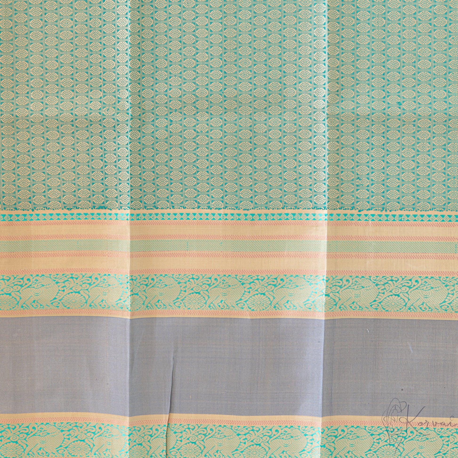 Closer view of the blouse fabric with grey double border and green jaquard design.