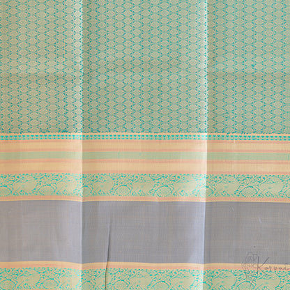 Closer view of the blouse fabric with grey double border and green jaquard design.