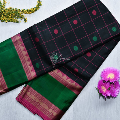 Top view of black soft silk saree with dark pink checks and double border in pink featuring Thalampoo and Rudraksham motifs.