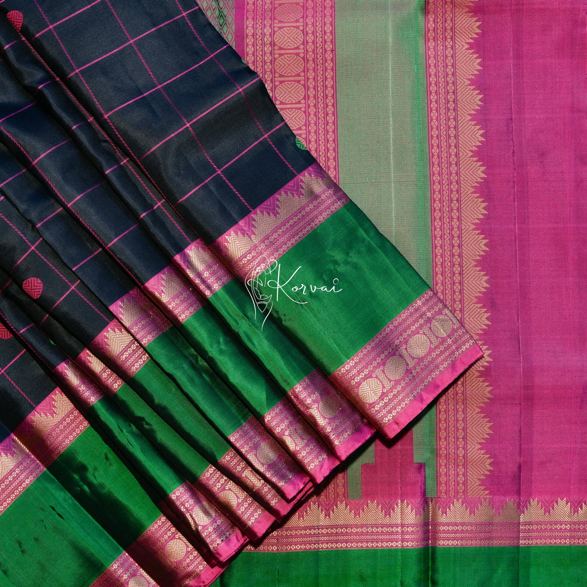 Black soft silk saree with pink checks and Rudraksham motifs in pink and green and Mayil kan motifs in the pallu.