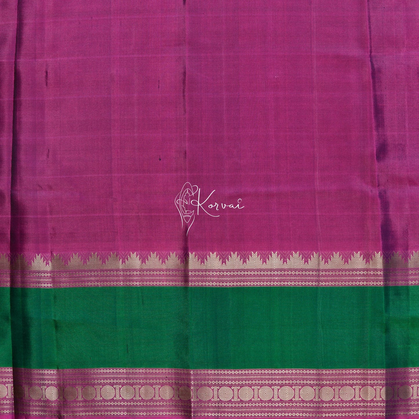 Closer view of blouse fabric that is pink and has green and pink double border as the saree.