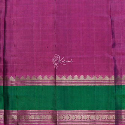 Closer view of blouse fabric that is pink and has green and pink double border as the saree.