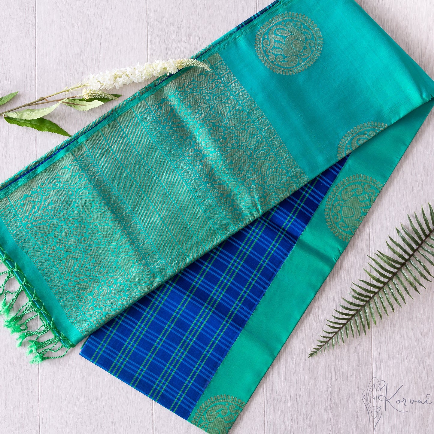 Royal blue korvai Kanjivaram soft silk saree with teal checks in the body and teal pallu.