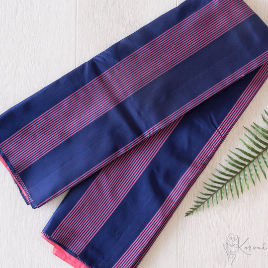 Dark blue Kanjivaram soft silk saree with baby pink vertical stripes.