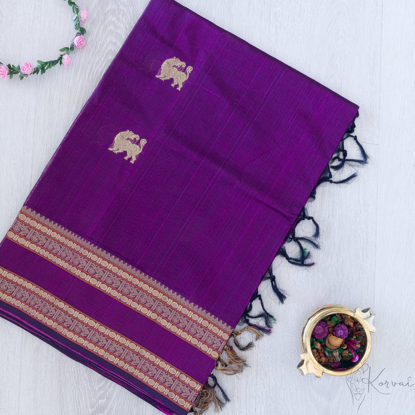 Violet silk cotton saree with double border and yaali motifs.