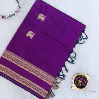 Violet silk cotton saree with double border and yaali motifs.