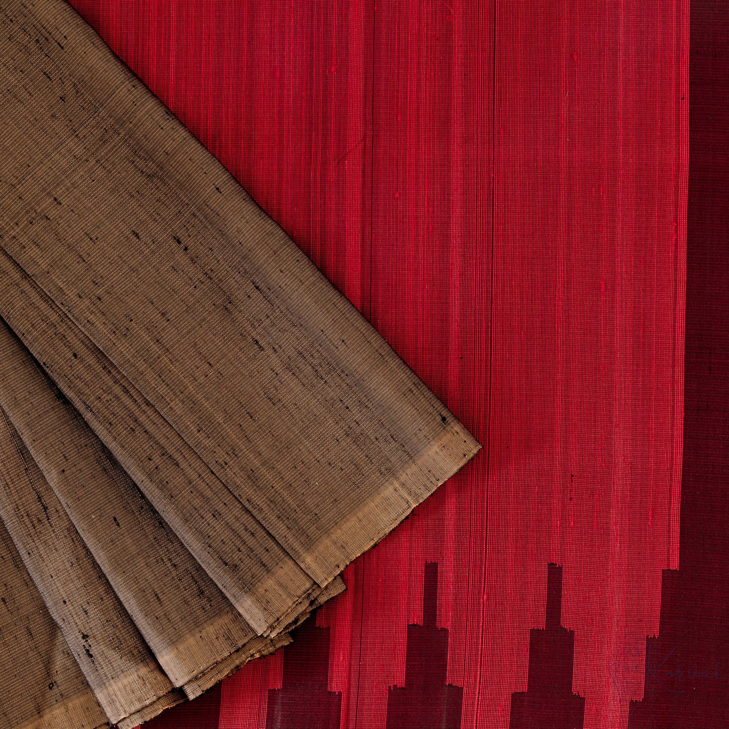 Top view of gold Kanjivaram soft silk saree displaying the red pallu in detail.