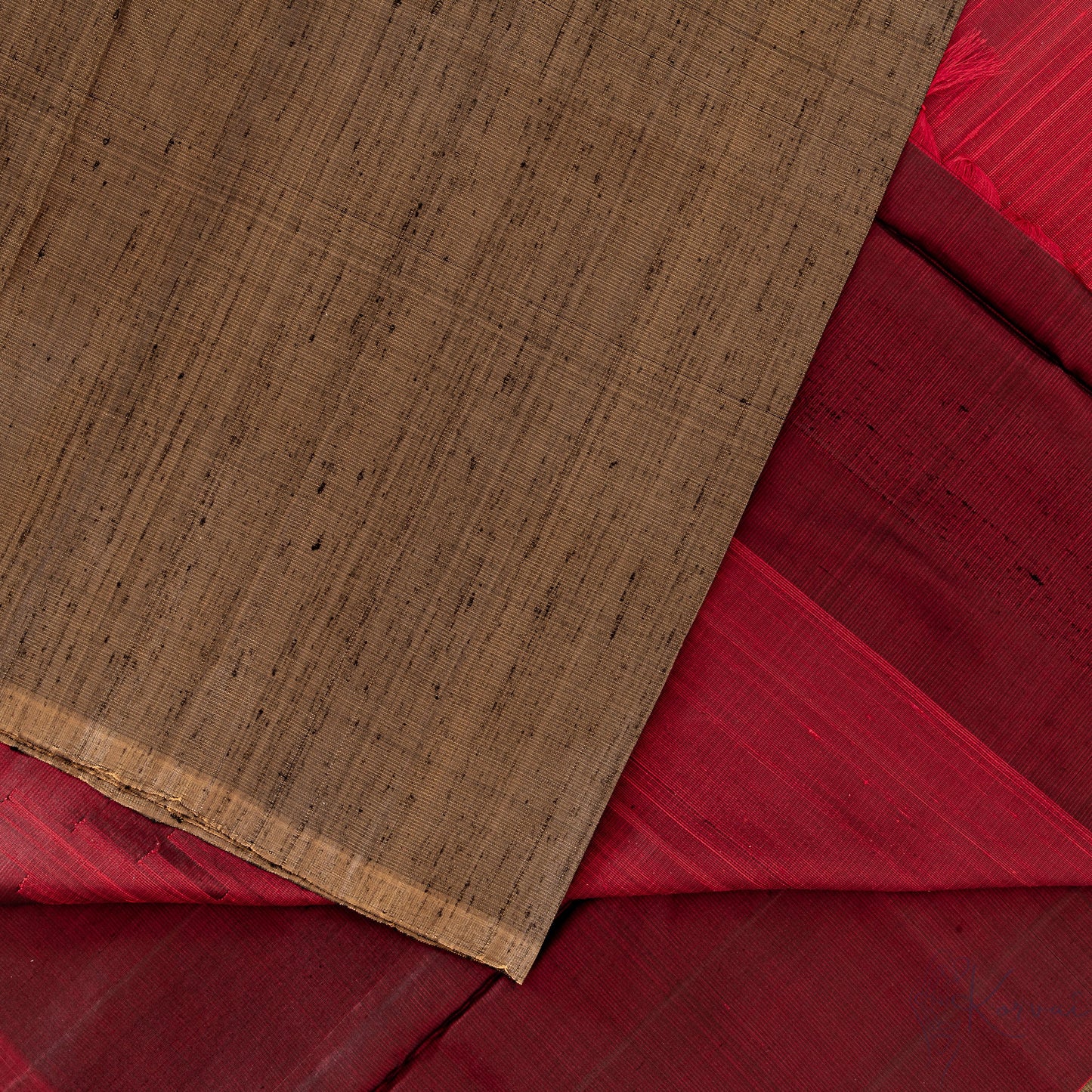 Top view of gold Kanjivaram soft silk saree displaying the red pallu in detail.