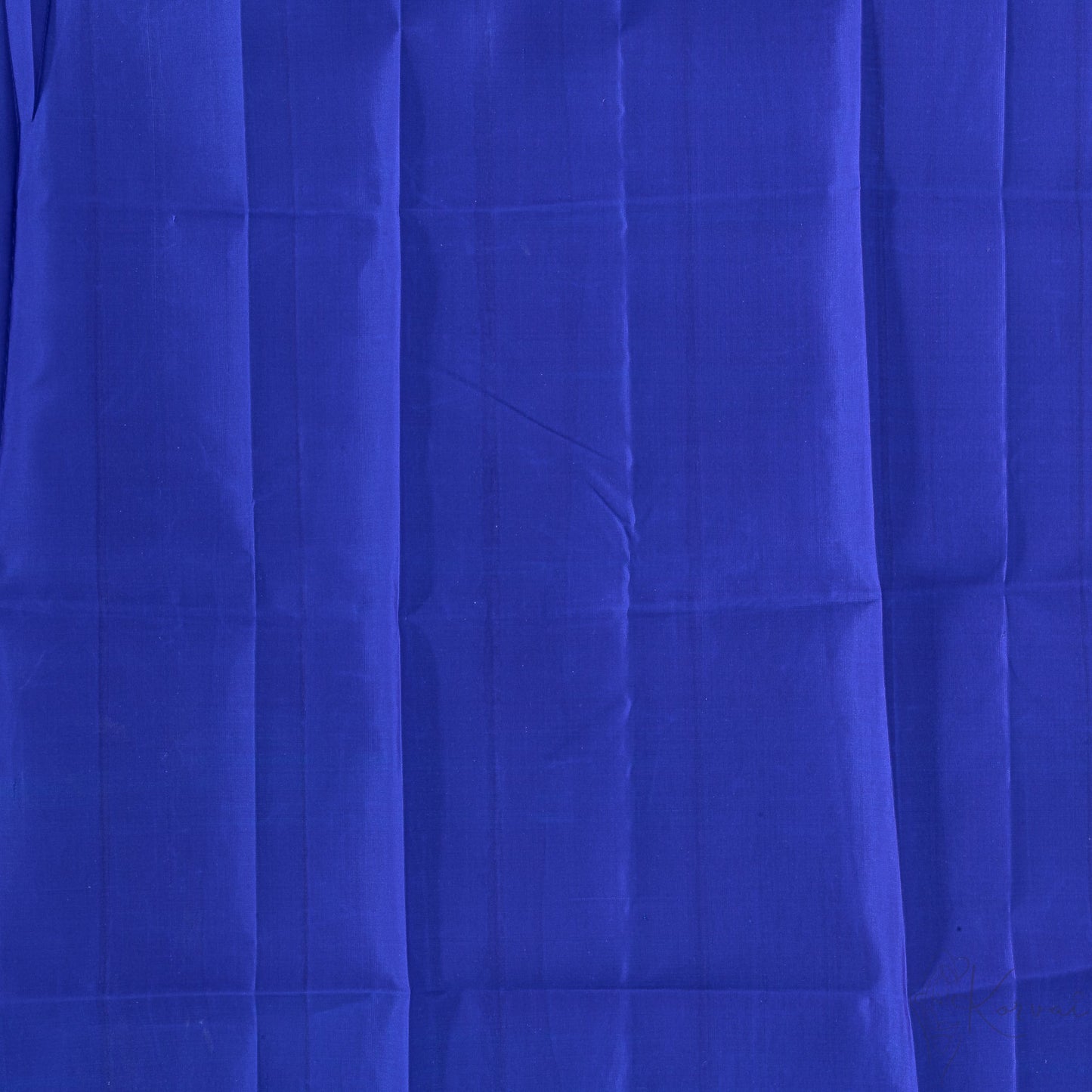 Closer view of plain blue blouse fabric.