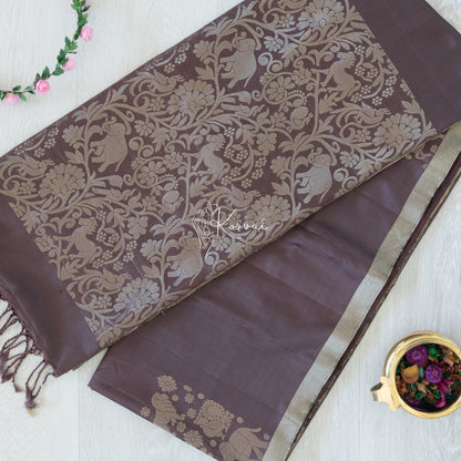 Top view of hickory coloured Kanjivaram soft silk saree with vanasingaram motifs in gold zari on the pallu.