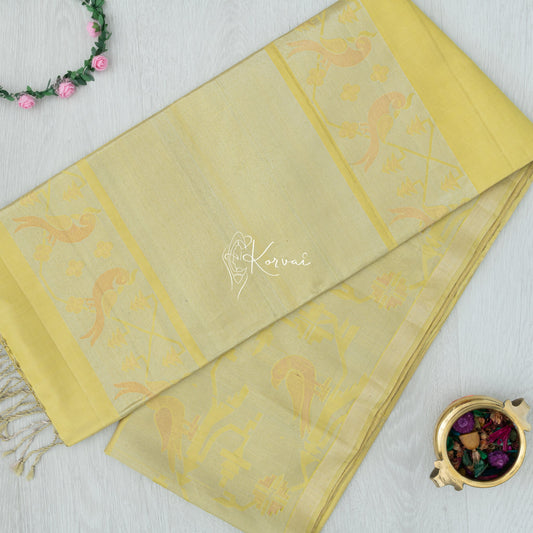 Top view of bright yellow coloured Kanjivaram soft silk saree with parrot and cockatoo motifs in gold, silver and copper zari on the pallu.