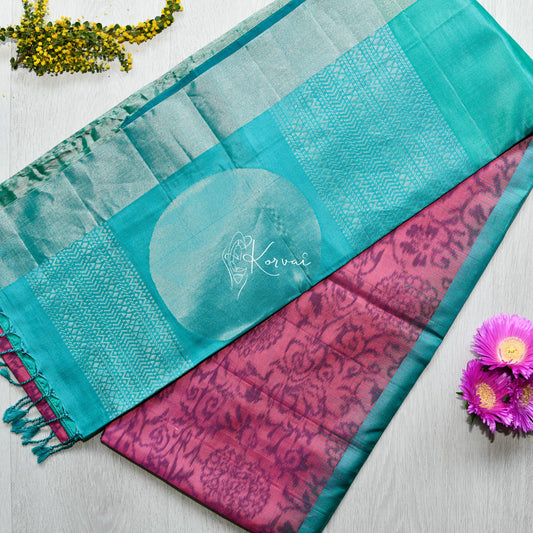 Top view of magenta coloured soft silk saree pochampally print on the body and sea blue coloured border featuring circle motifs.