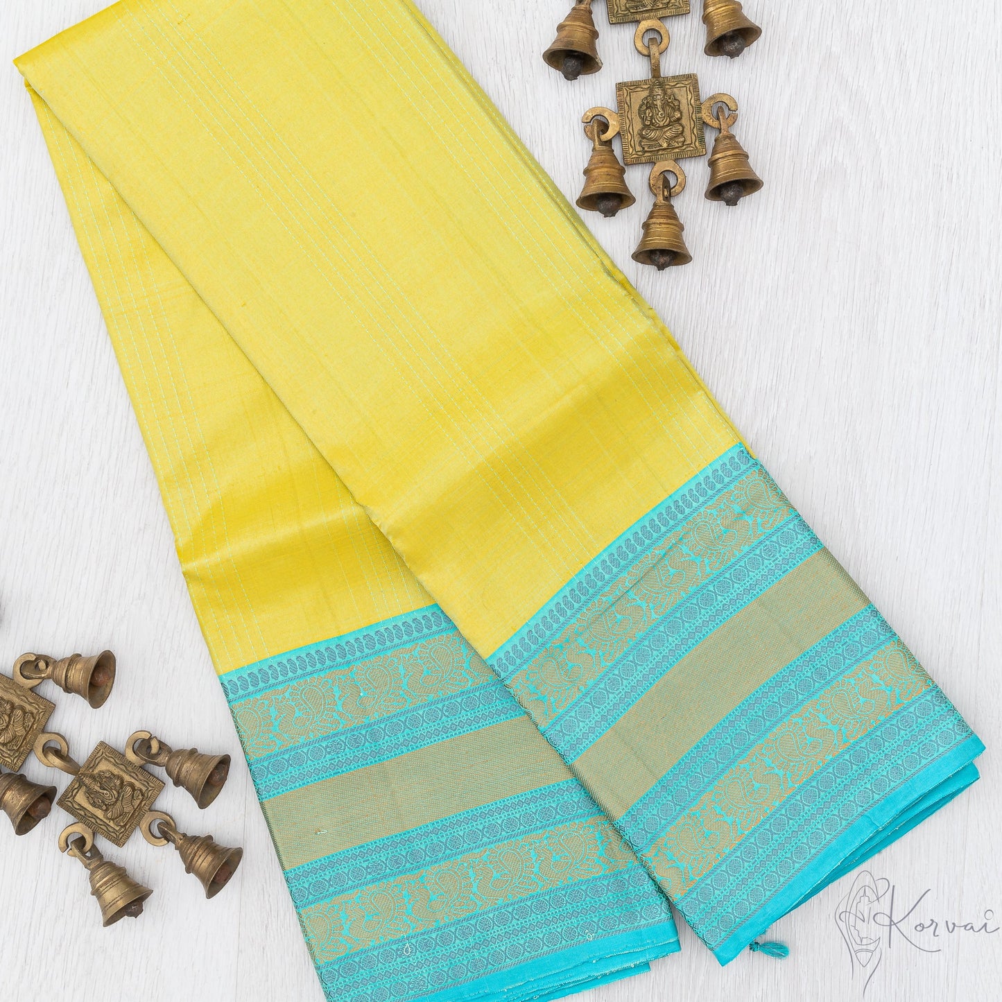 Lemon yellow Kanjivaram soft silk saree with teal vaira oosi stripes running vertically.