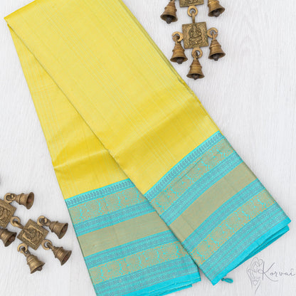 Lemon yellow Kanjivaram soft silk saree with teal vaira oosi stripes running vertically.