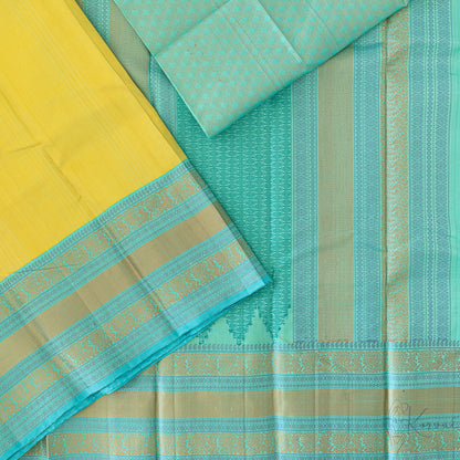 Lemon yellow Kanjivaram soft silk saree with teal double border and teal pallu.