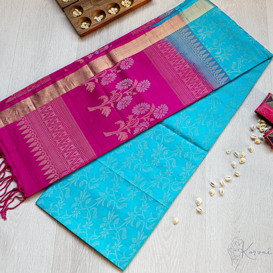 Coppersulphate blue Kanjivaram soft silk saree with silver vine motifs all through the body and magenta coloured pallu.