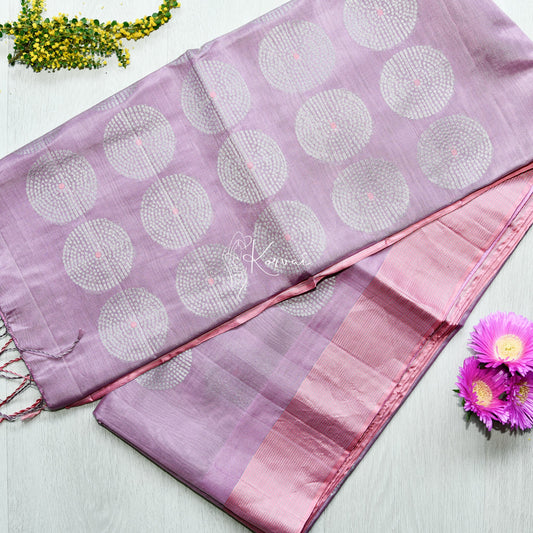 Top view of purple tussar silk saree with pink border featuring dotted circle motifs.