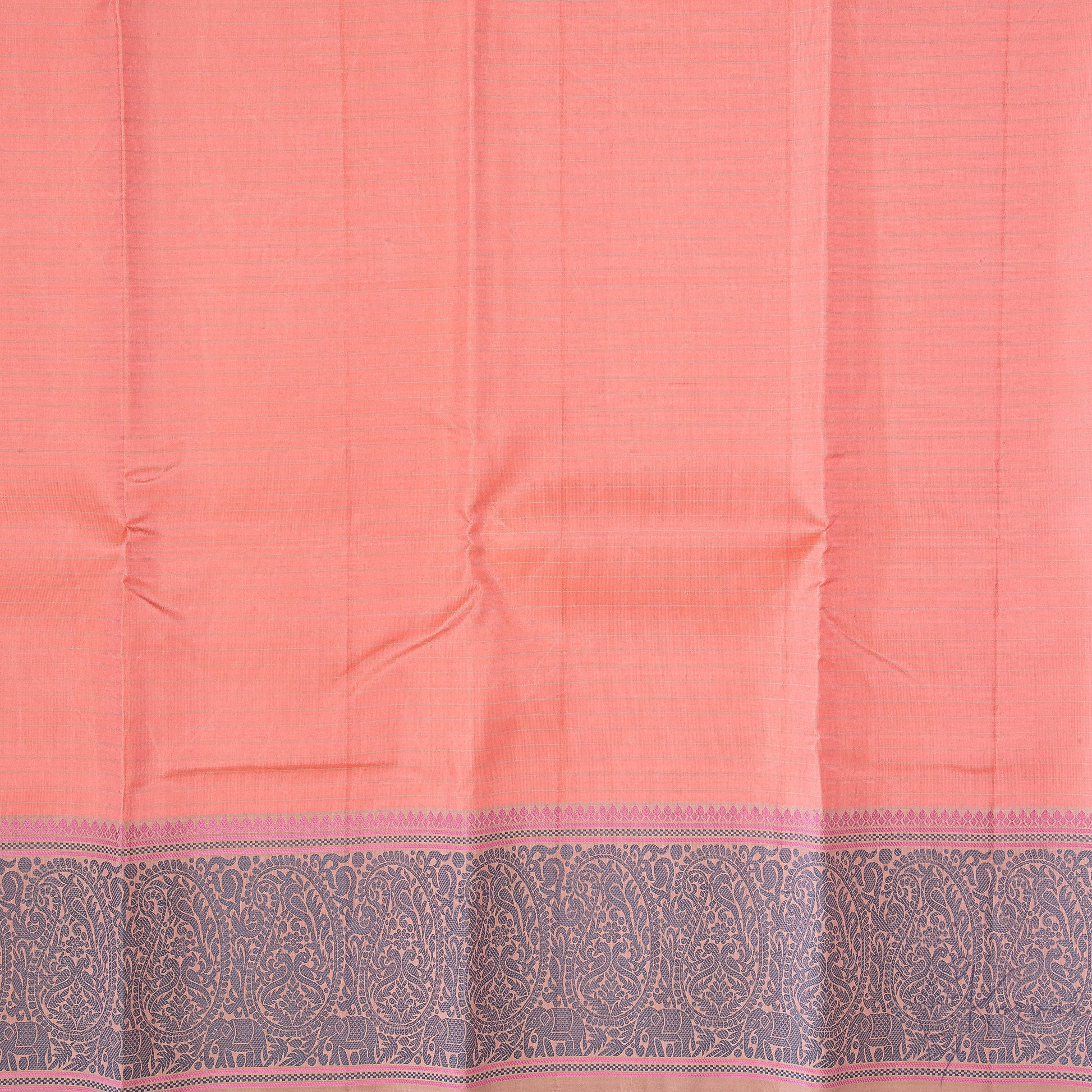 Closer view of the peach coloured body of the saree with cream stripes running horizontally and grey paisley motifs in the border.