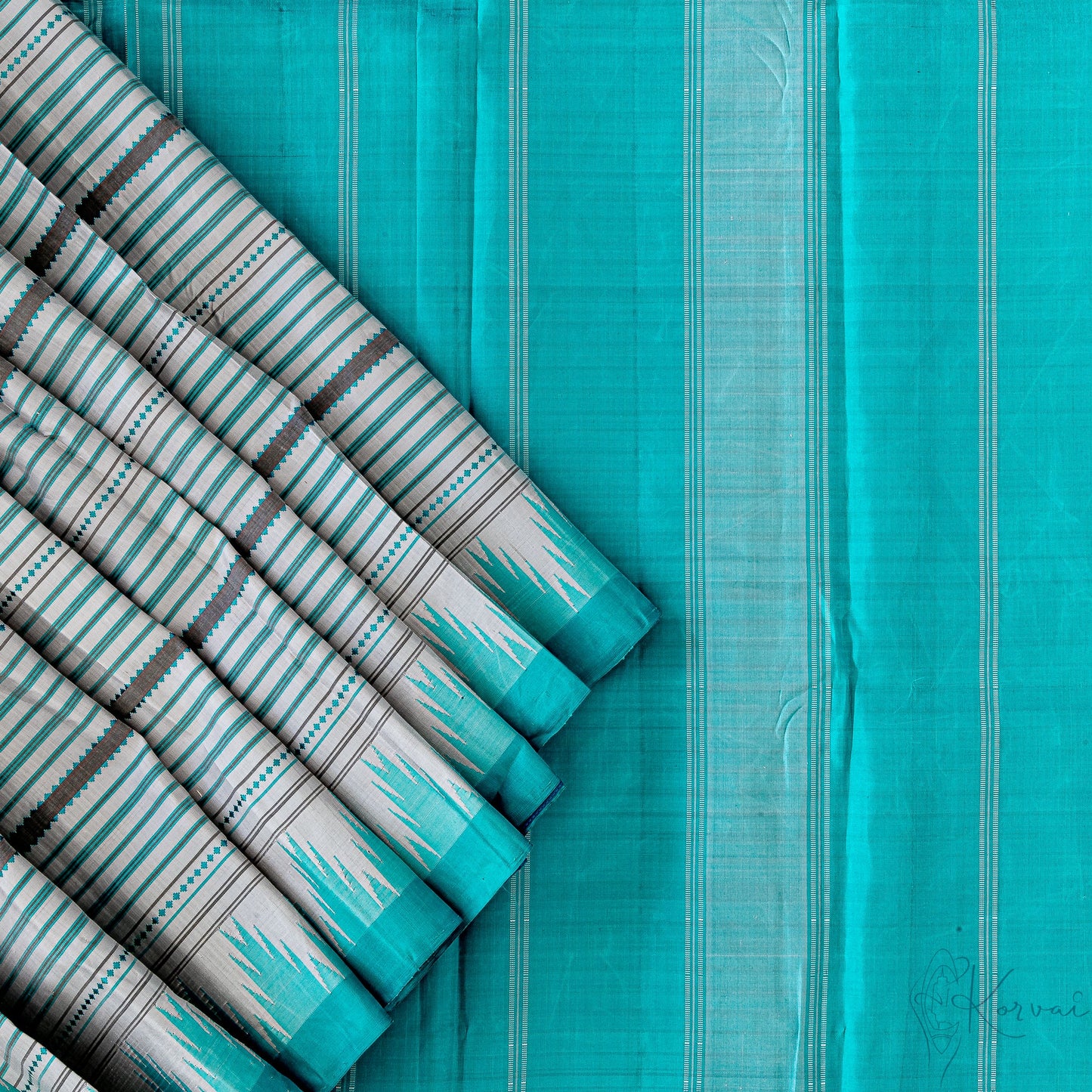 Top view of grey Kanjivaram saree with closer view of teal pallu with white stripes.